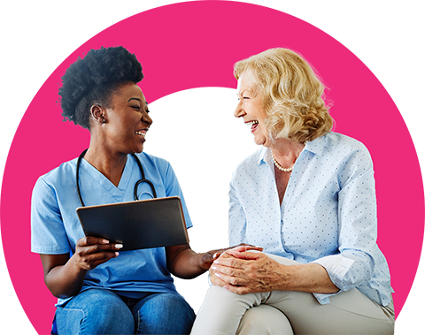 Patient and nurse laughing at an iPad