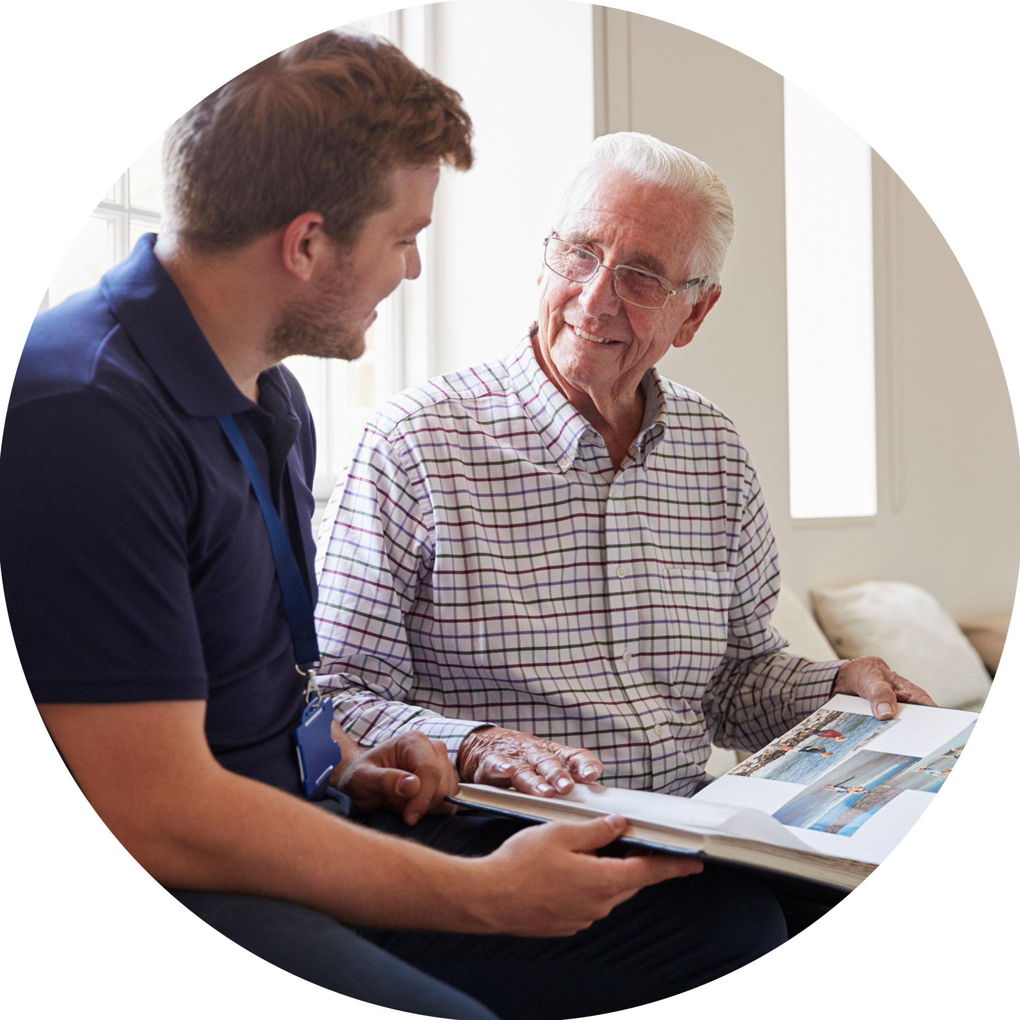 man and carer looking at photo album